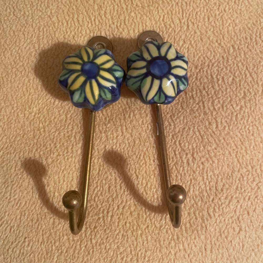 SOLD.  GLASS FLOWER BRASS HOOKS (2)
